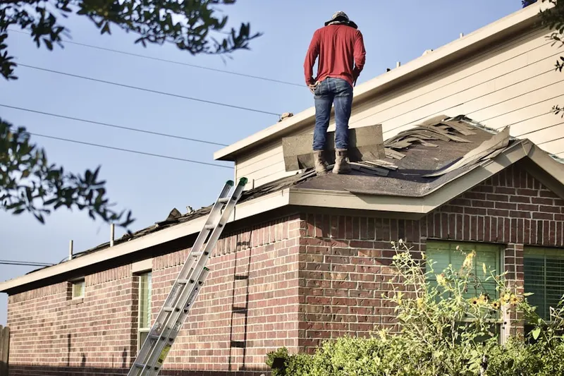 Professional roofer working on a residential roof in Piñata District